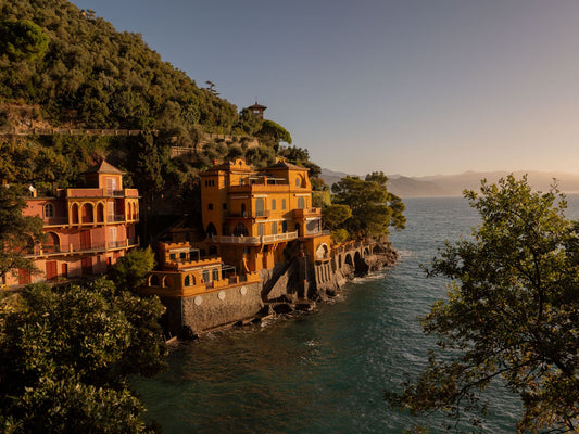 Italian Riviera Villas built on top of the cliffs in Baia Cannone, near Portofino, under the soft golden morning light.