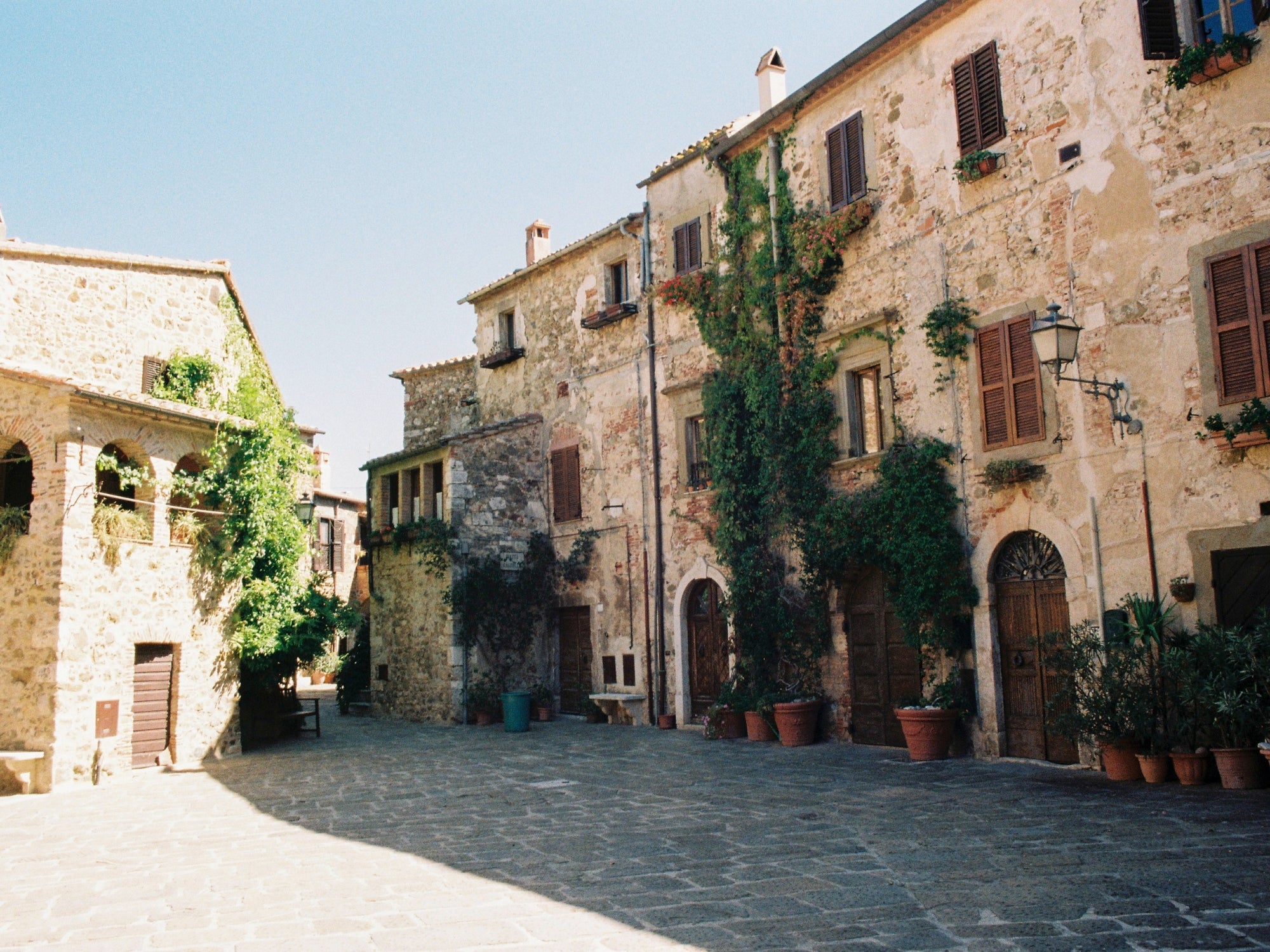 The central square of the medieval village of Montemerano, in Tuscany, with limestone houses and cobbled streets