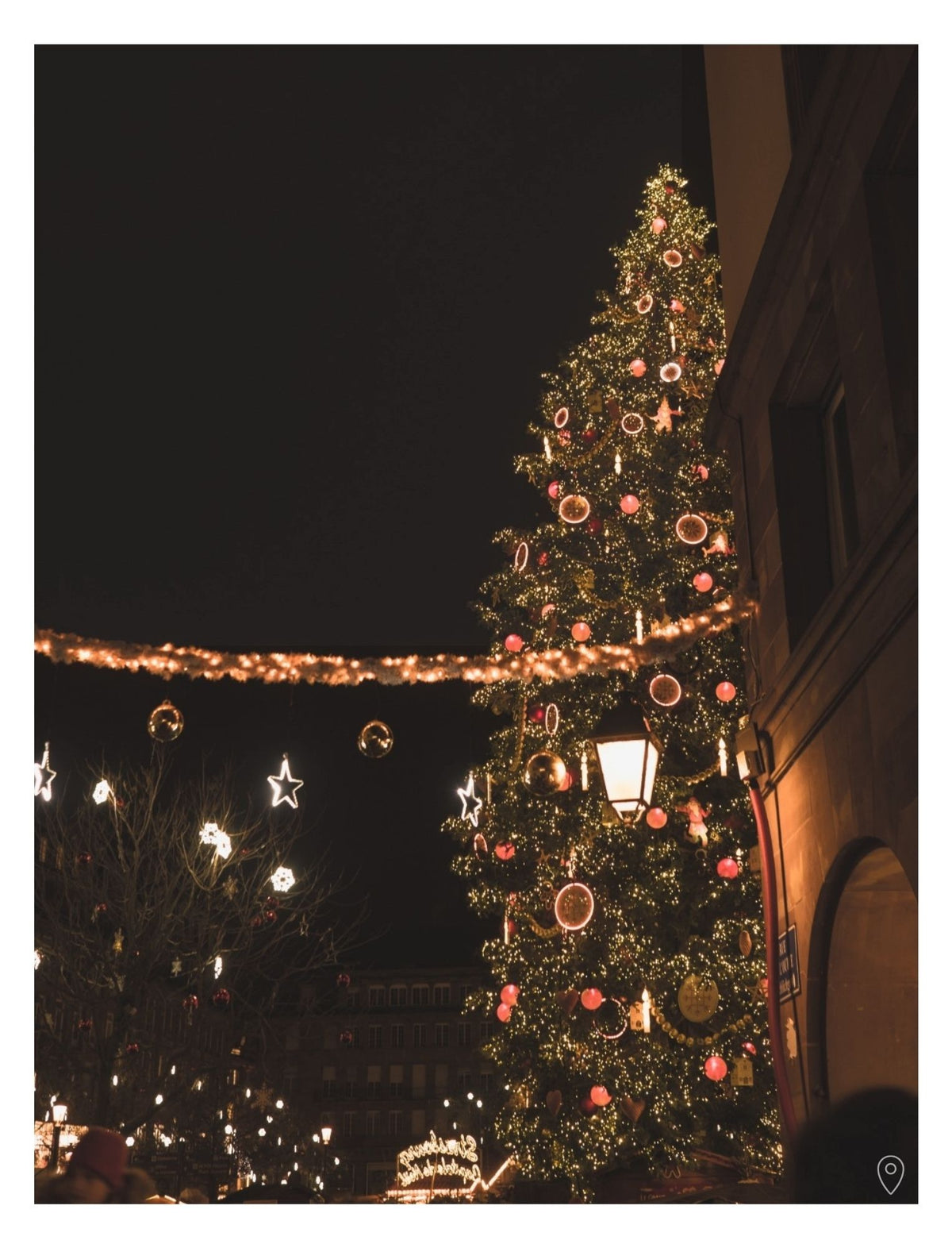 A picture of the illuminated Grand Sapin in Place Kléber, in Strasbourg, from the Guide to Alsace at Christmas, by Simply Slow Traveler.