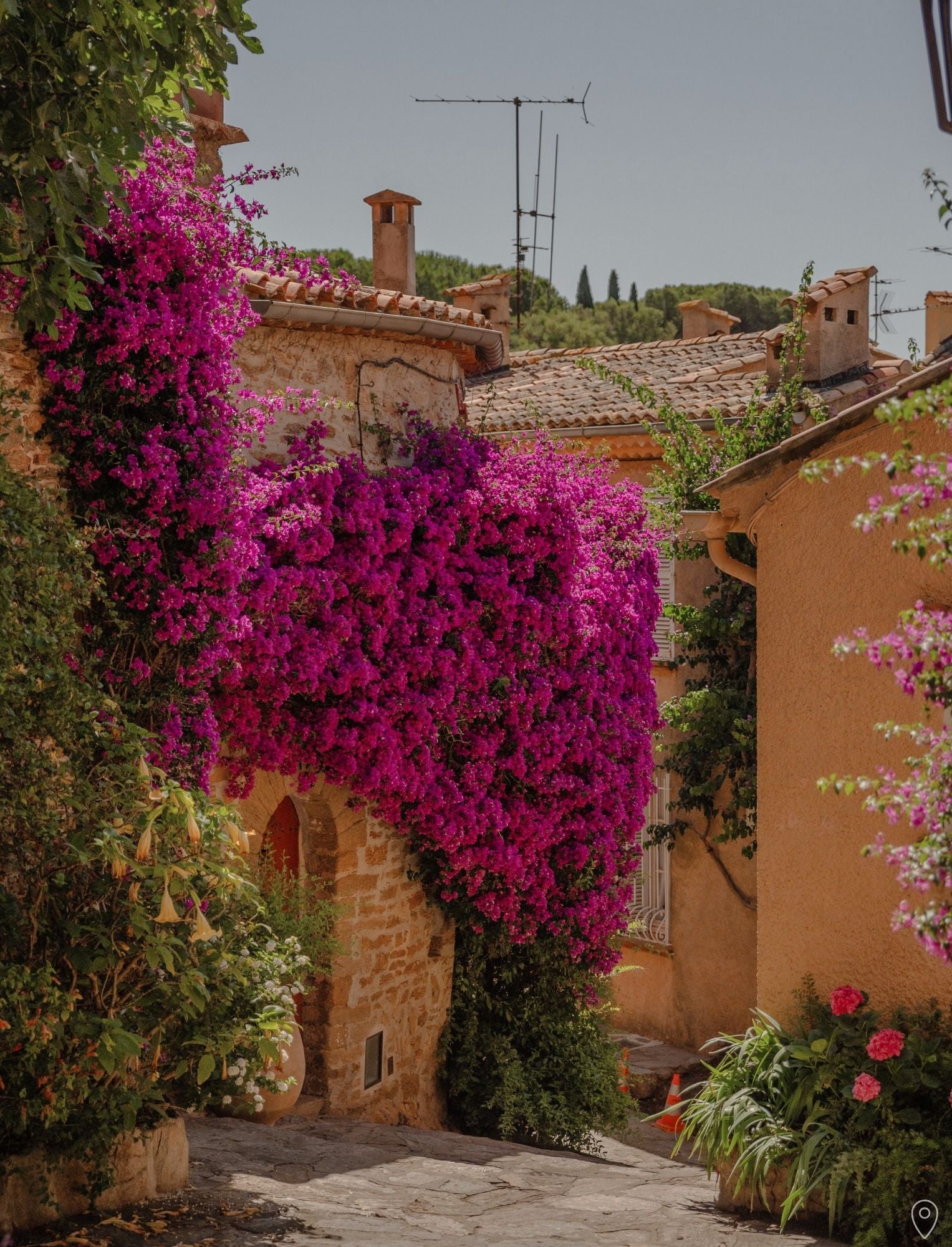 A Guide to the French Riviera in 14 Days - page with photo of a flowery street at Bormes-les-Mimosas, by Simply Slow Traveler