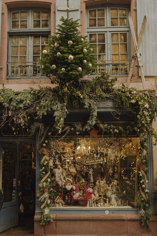 A window display with Christmas decorations and illuminations in Alsace