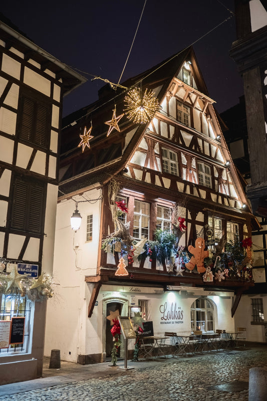 The façade of the restaurant Lohkäs decorated with Christmas Trees and large Gingerbread men, in Strasbourg