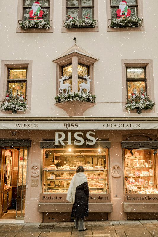 Window of a pasty shop in Strasbourg, Alsace, decorated for Christmas, on a December snowy morning