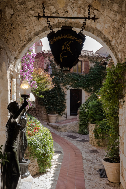 An passage under an arch in the cobbled streets of the medieval village of Èze, on the French Riviera