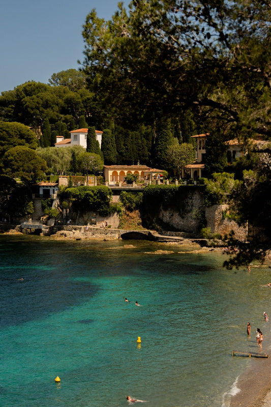 The turquoise waters of Paloma Beach, in Cap-Ferrat, surrounded by dense vegetation and luxury water front villages