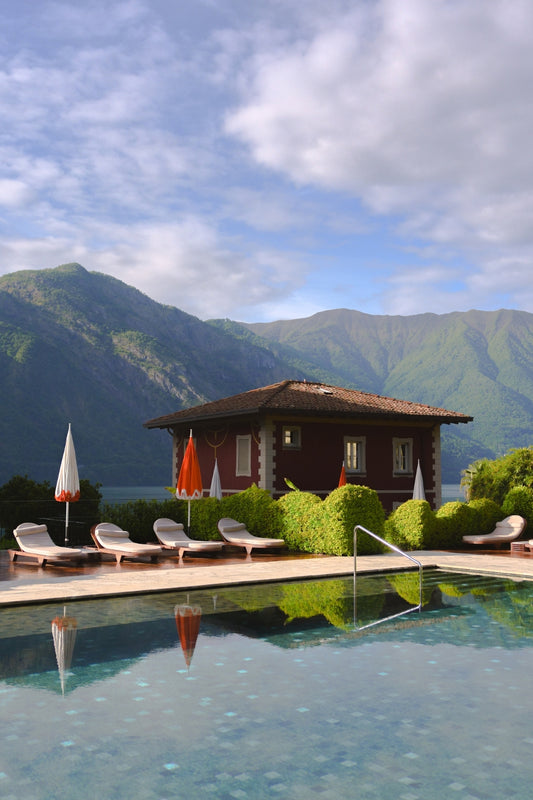 The swimming pool at Grand Hotel Tremezzo with Lake Como and its surrounding hills afar