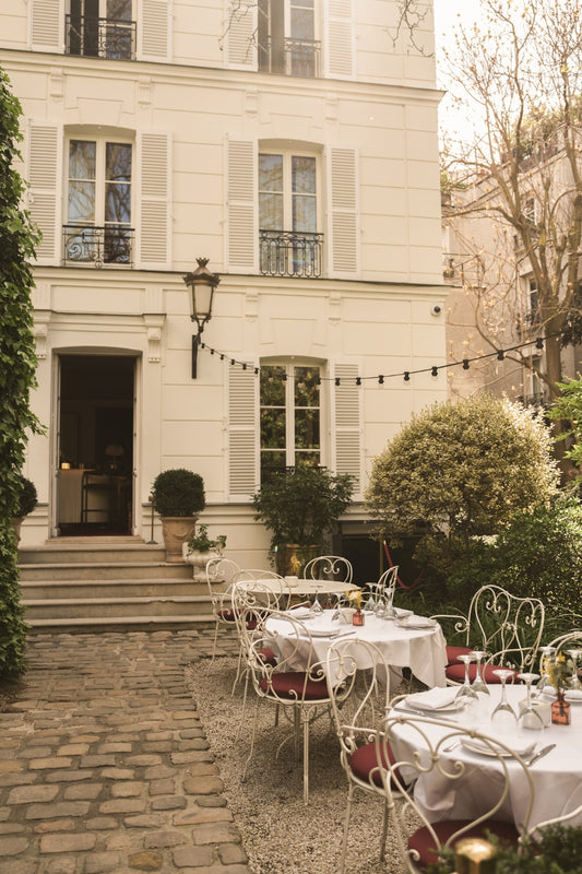 The courtyard of Hôtel Particulier de Montmartre, in Paris, with the tables set out for lunchtime