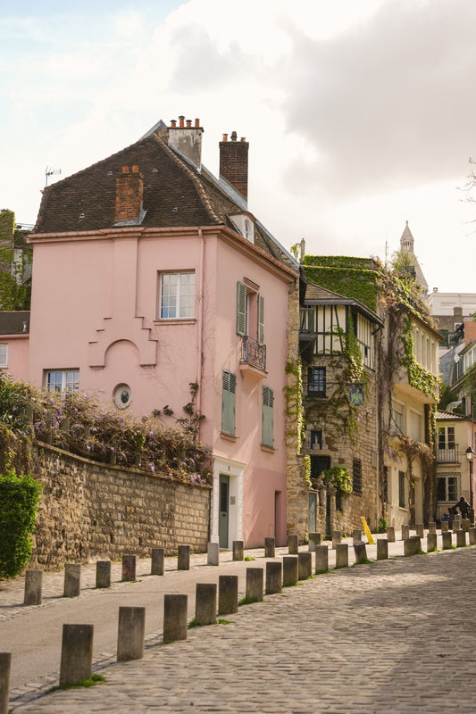 Rue de l'Abreuvoir, in Montmartre, Paris, with its characteristic cobbled street and the pink and ivy covered façades