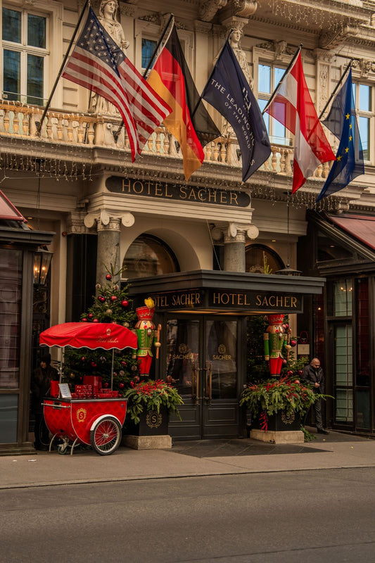 The entrance of the Hotel Sacher, in Vienna, with a Christmas tree and a large-sized wooden nutcracker to either side.