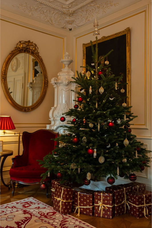 The presents wrapped in red and golden paper under the Christmas Tree at a suite in the Hotel Sacher