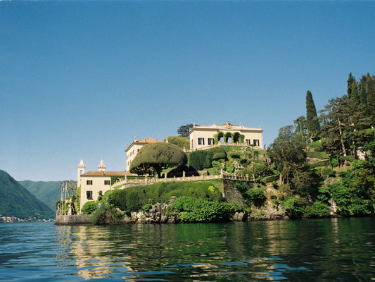Views of Villa del Balbianello and its gardens from a boat in Lake Como