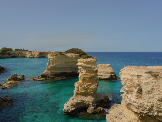The Faraglioni di Sant'Andrea in a turquoise waters bay along the coast of Salento, in Puglia, Italy