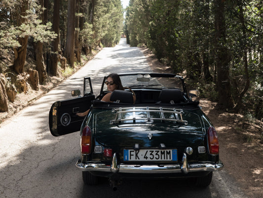 A classic car on a ride through the Tuscan countryside