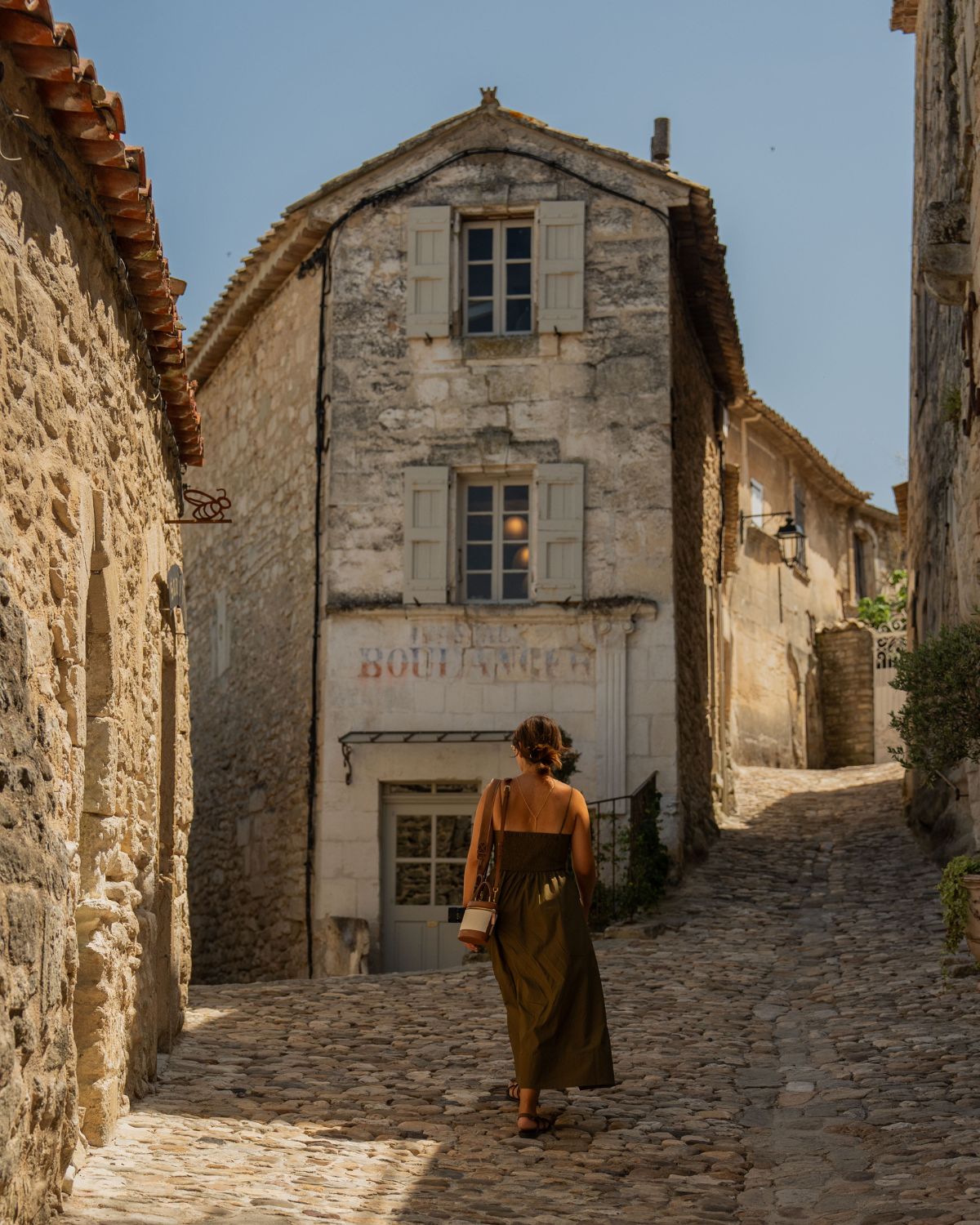 Cobblestone street in Lacoste with shuttered windows.