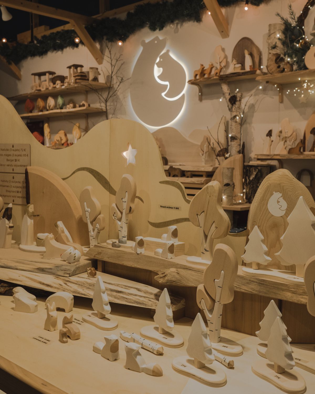 White and beige wooden toys, on a Christmas market stand.