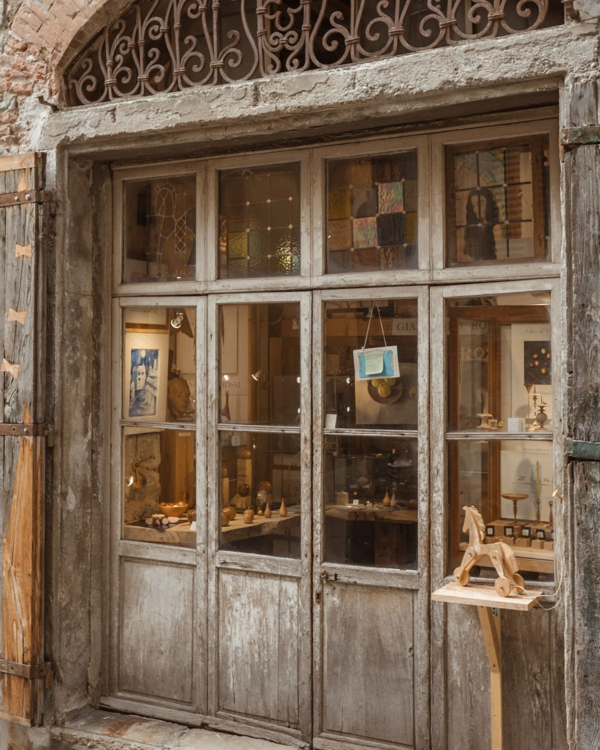 Old wooden door with glasses to see the interior with random objects.