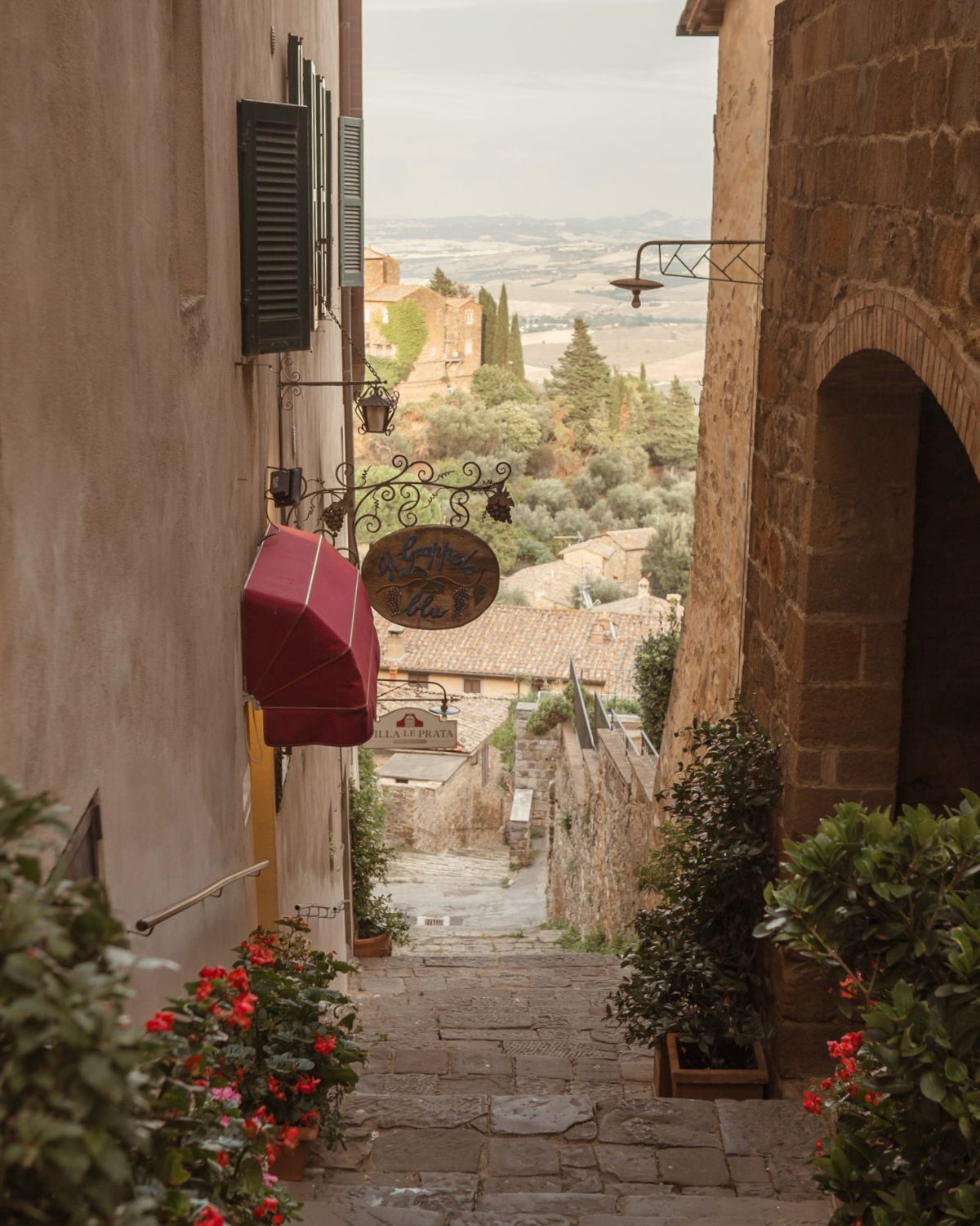 Street alley on a hill, with valleys in the background and a golden light shimmering.