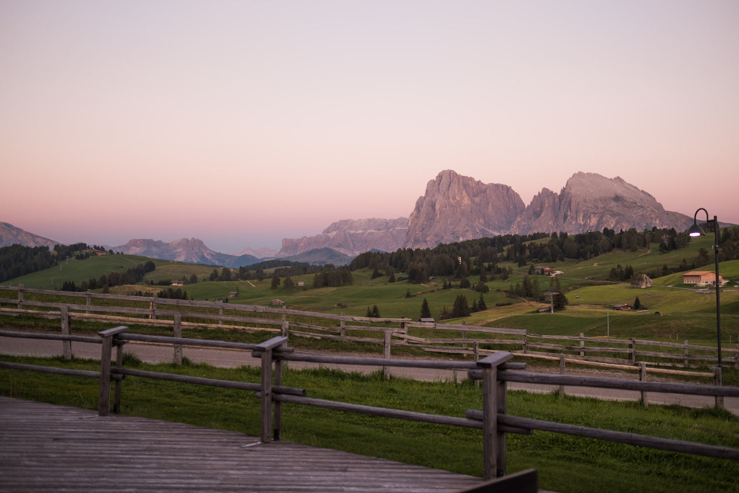 Mountains and a green valley at sunset.