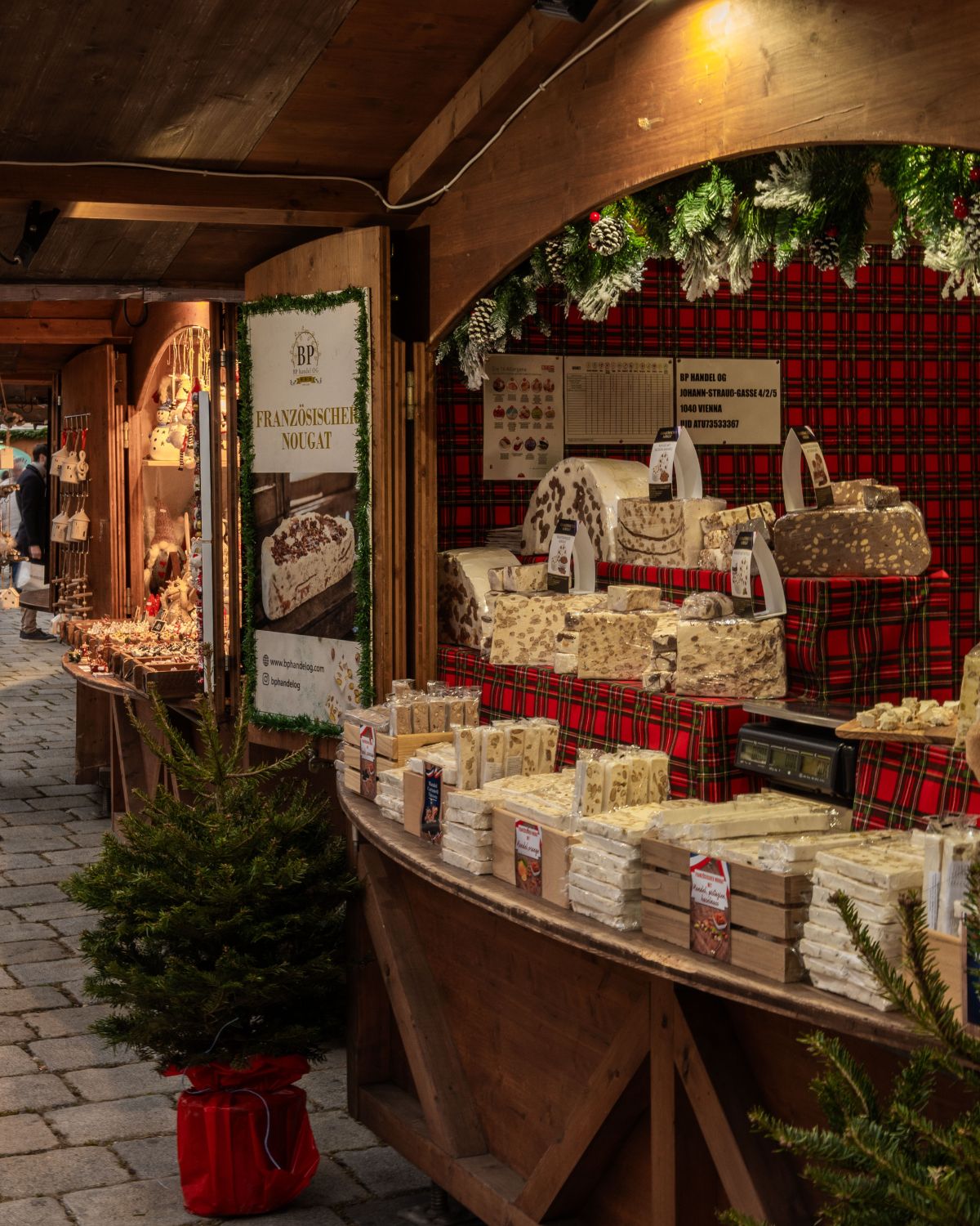 A Christmas market wooden stand, with products on display and Christmas ornaments.